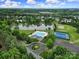 Aerial view of neighborhood amenities including pool, tennis courts, pond, and clubhouse in a green, serene setting at 4016 Garden Oak Dr, Indian Trail, NC 28079