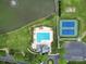 Aerial view of community amenities featuring a pool, tennis courts, and lakeside setting with ample parking at 4016 Garden Oak Dr, Indian Trail, NC 28079