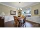 Well-lit dining room with hardwood floors, a view of the neighborhood, and traditional decor at 4016 Garden Oak Dr, Indian Trail, NC 28079
