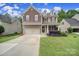Charming two-story home featuring a well-manicured lawn and beautifully landscaped front yard at 4016 Garden Oak Dr, Indian Trail, NC 28079