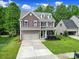 Attractive two-story home with a two-car garage, beautiful landscaping, and inviting curb appeal at 4016 Garden Oak Dr, Indian Trail, NC 28079