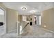 Well-lit hallway with carpet flooring, offering access to different rooms in the house at 4016 Garden Oak Dr, Indian Trail, NC 28079