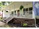 Inviting front porch features white railings, swing, and lush hanging plants at 432 Partridge Pl, York, SC 29745