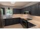 Modern kitchen with stainless steel appliances, dark cabinets, and white countertops at 432 Partridge Pl, York, SC 29745