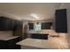 Modern kitchen featuring dark cabinets, stainless steel appliances, and white countertops at 432 Partridge Pl, York, SC 29745