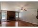 Inviting living room featuring hardwood floors and a cozy brick fireplace at 432 Partridge Pl, York, SC 29745