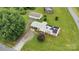 Aerial view of a single-Gathering home featuring solar panels, a metal roof, a long driveway, and a spacious yard at 543 18Th Nw St, Hickory, NC 28601