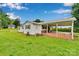 Expansive backyard featuring a white-sided house, a covered patio and lush lawn, perfect for outdoor activities at 543 18Th Nw St, Hickory, NC 28601
