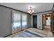 Bedroom featuring blue paneled walls, large window and carpeted floors at 543 18Th Nw St, Hickory, NC 28601