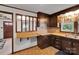 Kitchen featuring dark wood cabinets, lighter countertops and a breakfast bar pass-through at 543 18Th Nw St, Hickory, NC 28601