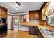 Kitchen featuring dark wood cabinets, sink with window view and access to living room at 543 18Th Nw St, Hickory, NC 28601