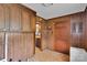 Laundry room with storage cabinets, wood-paneled walls, and tile flooring at 543 18Th Nw St, Hickory, NC 28601