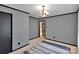 Cozy living room featuring wood paneling and classic chandelier lighting at 543 18Th Nw St, Hickory, NC 28601