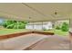 Covered patio with concrete flooring and brick accents overlooking the detached garage and landscaped backyard at 543 18Th Nw St, Hickory, NC 28601