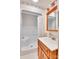 Well-lit bathroom with a shower, vanity, wood cabinets, and large mirror at 6447 E Nc 27 Hwy, Iron Station, NC 28080