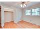 Bright bedroom with wood floors, closet, and windows at 6447 E Nc 27 Hwy, Iron Station, NC 28080
