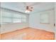 Light bedroom with wood floors and trim, white walls, and modern ceiling fan at 6447 E Nc 27 Hwy, Iron Station, NC 28080