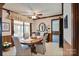 Inviting dining room featuring wood accents, an oval table with seating for four, and a view of the screened porch at 6447 E Nc 27 Hwy, Iron Station, NC 28080