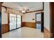 This dining room features wood trim, a ceiling fan, and access to a sunroom, perfect for gatherings at 6447 E Nc 27 Hwy, Iron Station, NC 28080
