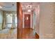 The home's entry features a wood door, wood flooring, and decorative wallpaper, creating an inviting atmosphere at 6447 E Nc 27 Hwy, Iron Station, NC 28080