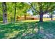 Beautifully landscaped front yard featuring a single-story home with mature trees and a well-maintained lawn at 6447 E Nc 27 Hwy, Iron Station, NC 28080