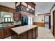 Classic kitchen featuring wood cabinets, a center island, black appliances, and a unique lighting fixture at 6447 E Nc 27 Hwy, Iron Station, NC 28080
