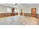 This room features wood paneling, a classic grandfather clock, and tile flooring, adding charm and functionality at 6447 E Nc 27 Hwy, Iron Station, NC 28080