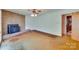 This living room features a stone fireplace and wood-paneled walls, creating a cozy and inviting space at 6447 E Nc 27 Hwy, Iron Station, NC 28080