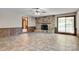 This spacious living room features a stone fireplace and a sliding glass door, blending comfort and functionality at 6447 E Nc 27 Hwy, Iron Station, NC 28080