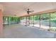Expansive screened patio with ceiling fan, offering a serene view of the lush outdoor surroundings, with exterior brick at 6447 E Nc 27 Hwy, Iron Station, NC 28080