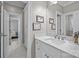 A bright bathroom featuring a vanity with white countertop and fixtures at 6824 N Baltusrol Ln, Charlotte, NC 28210
