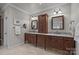 Bathroom featuring and dark wood vanities, granite counters, and tile floors at 6824 N Baltusrol Ln, Charlotte, NC 28210
