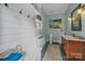 Charming bathroom with blue walls, white trim, and a beach-themed painting at 6824 N Baltusrol Ln, Charlotte, NC 28210
