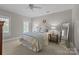Bedroom with carpet, ceiling fan, two windows with shutters, and modern-style furnishings at 6824 N Baltusrol Ln, Charlotte, NC 28210