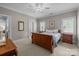 Comfortable bedroom featuring a ceiling fan, two windows with shutters, and traditional-style furnishings at 6824 N Baltusrol Ln, Charlotte, NC 28210