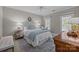 Comfortable bedroom featuring a ceiling fan, two windows with shutters, and traditional-style furnishings at 6824 N Baltusrol Ln, Charlotte, NC 28210