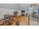Spacious bonus room featuring hardwood floors, desk and office space, ceiling fan and gym equipment at 6824 N Baltusrol Ln, Charlotte, NC 28210