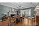 Traditional dining room with a large wooden table, fireplace, and bright natural light at 6824 N Baltusrol Ln, Charlotte, NC 28210