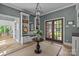 Inviting foyer features a built-in storage bench, decorative accents, and a glass front door at 6824 N Baltusrol Ln, Charlotte, NC 28210