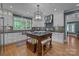 Bright kitchen boasts white cabinets, center island with seating, and stainless steel appliances at 6824 N Baltusrol Ln, Charlotte, NC 28210