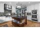 This kitchen features a kitchen island, stainless steel appliances, and white cabinets at 6824 N Baltusrol Ln, Charlotte, NC 28210