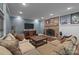 Finished basement featuring a gas fireplace, flat screen TV and sectional sofa seating at 6824 N Baltusrol Ln, Charlotte, NC 28210