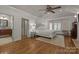 Serene main bedroom with hardwood floors, white accents, and bright windows with shutters at 6824 N Baltusrol Ln, Charlotte, NC 28210