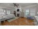 A spacious main bedroom featuring hardwood floors, fireplace, and plantation shutters at 6824 N Baltusrol Ln, Charlotte, NC 28210