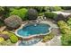 Aerial view of the luxurious pool area featuring a waterfall, spa, and expertly designed landscaping at 6824 N Baltusrol Ln, Charlotte, NC 28210