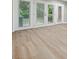Bright room with light wood flooring and glass doors providing access to the backyard at 7004 Quail Hill Rd, Charlotte, NC 28210