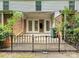 View of patio with black metal fence and access to building with multi-pane glass doors at 7004 Quail Hill Rd, Charlotte, NC 28210