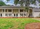 Inviting townhome showcasing a well-maintained lawn and classic colonial architectural details at 7004 Quail Hill Rd, Charlotte, NC 28210
