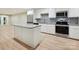Modern kitchen features stainless steel appliances, granite countertops, and light wood flooring at 7004 Quail Hill Rd, Charlotte, NC 28210