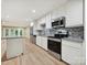 Modern kitchen features stainless steel appliances, granite countertops, and light wood flooring at 7004 Quail Hill Rd, Charlotte, NC 28210